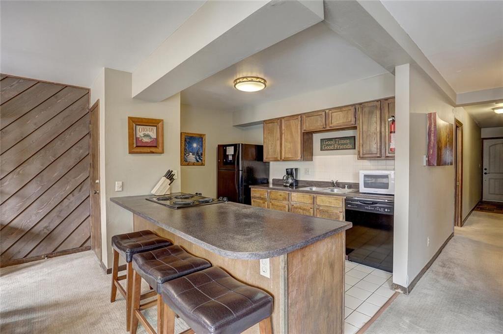 325 Four Oclock Road, Unit C203 Breckenridge, CO 80424 - Photo 18 of 35 a kitchen with stainless steel appliances granite countertop a stove refrigerator and a sink