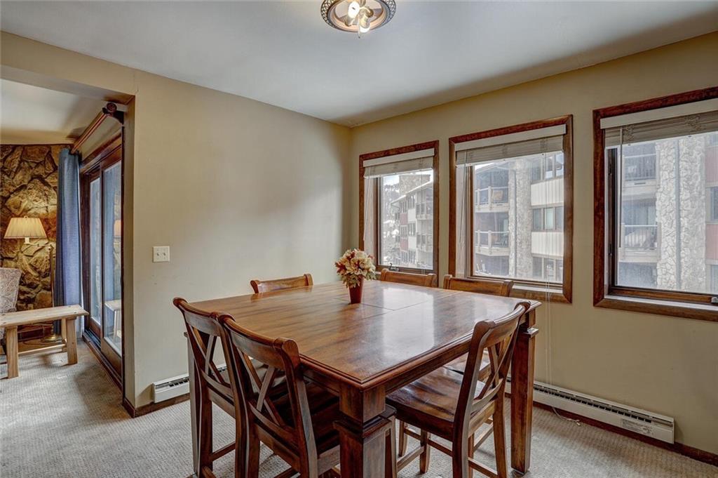 325 Four Oclock Road, Unit C203 Breckenridge, CO 80424 - Photo 20 of 35 a view of a dining room with furniture and window