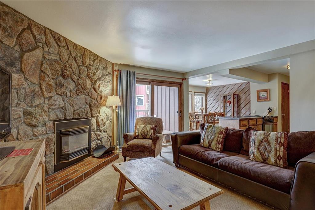325 Four Oclock Road, Unit C203 Breckenridge, CO 80424 - Photo 3 of 35 a living room with a couch and a fireplace