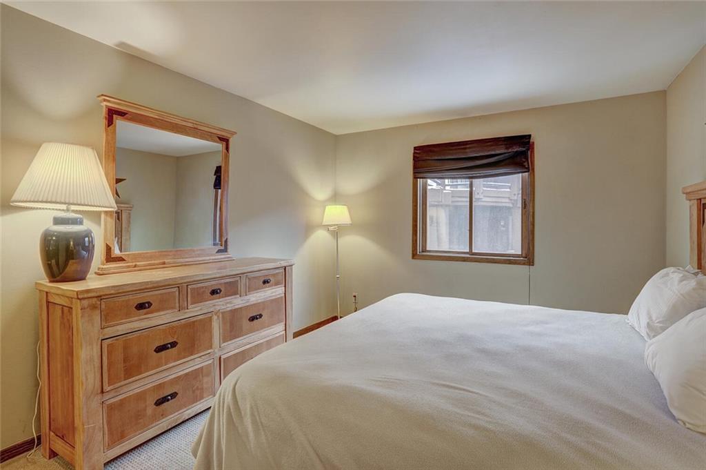 325 Four Oclock Road, Unit C203 Breckenridge, CO 80424 - Photo 22 of 35 a bedroom with a bed and a dresser