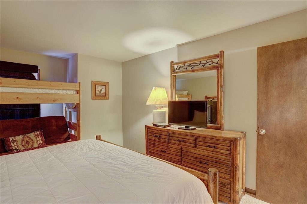 325 Four Oclock Road, Unit C203 Breckenridge, CO 80424 - Photo 27 of 35 a bedroom with a bed and a television