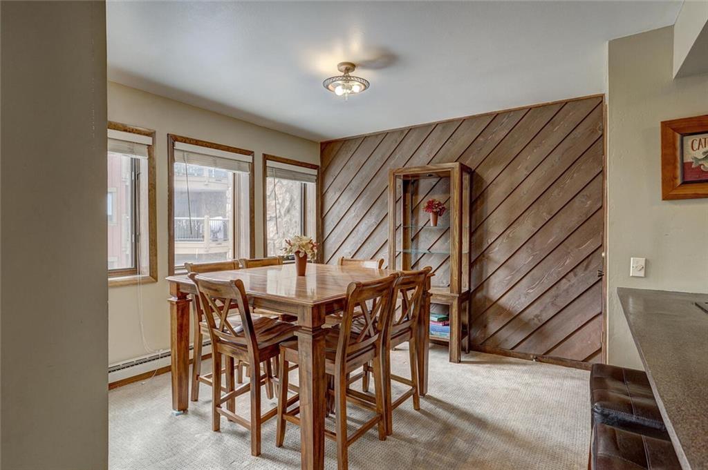 325 Four Oclock Road, Unit C203 Breckenridge, CO 80424 - Photo 4 of 35 a dining room with furniture and window