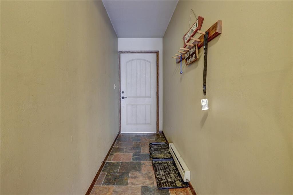 325 Four Oclock Road, Unit C203 Breckenridge, CO 80424 - Photo 33 of 35 a view of a hallway with wooden floor and a carpet