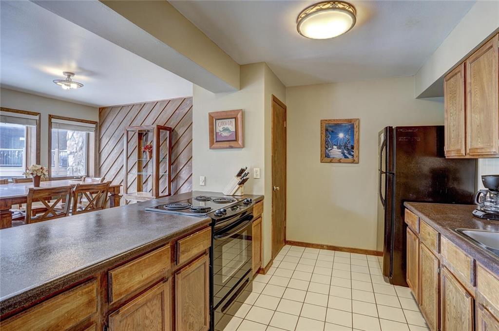 325 Four Oclock Road, Unit C203 Breckenridge, CO 80424 - Photo 9 of 35 a kitchen with stainless steel appliances granite countertop a refrigerator stove and sink