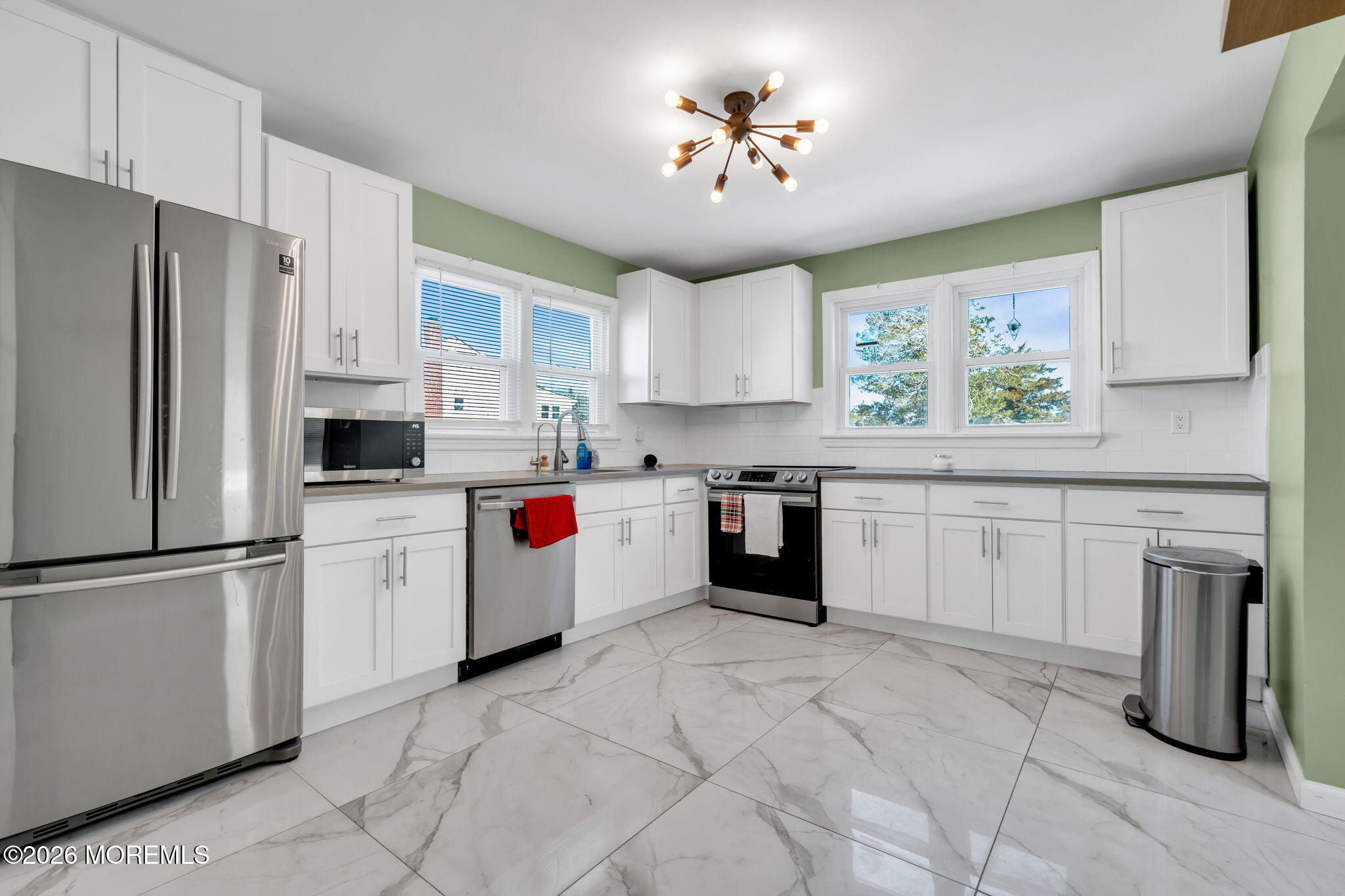 a kitchen with cabinets and stainless steel appliances