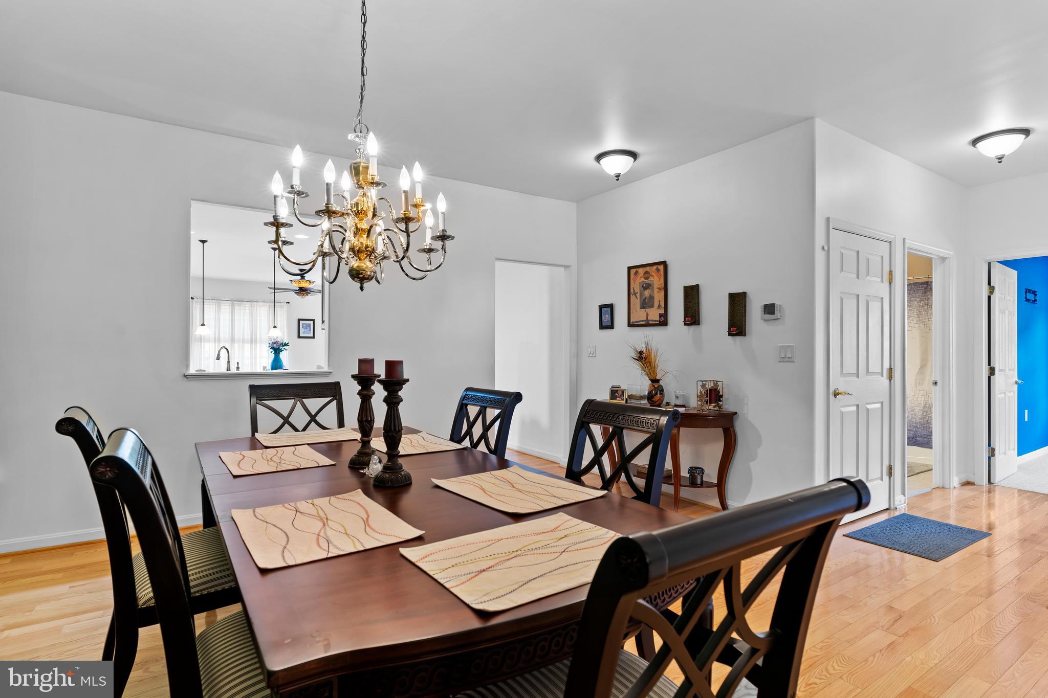 152 St Michaels Way Hanover, PA 17331 - Photo 14 of 37 a view of a dining room with furniture a chandelier and wooden floor