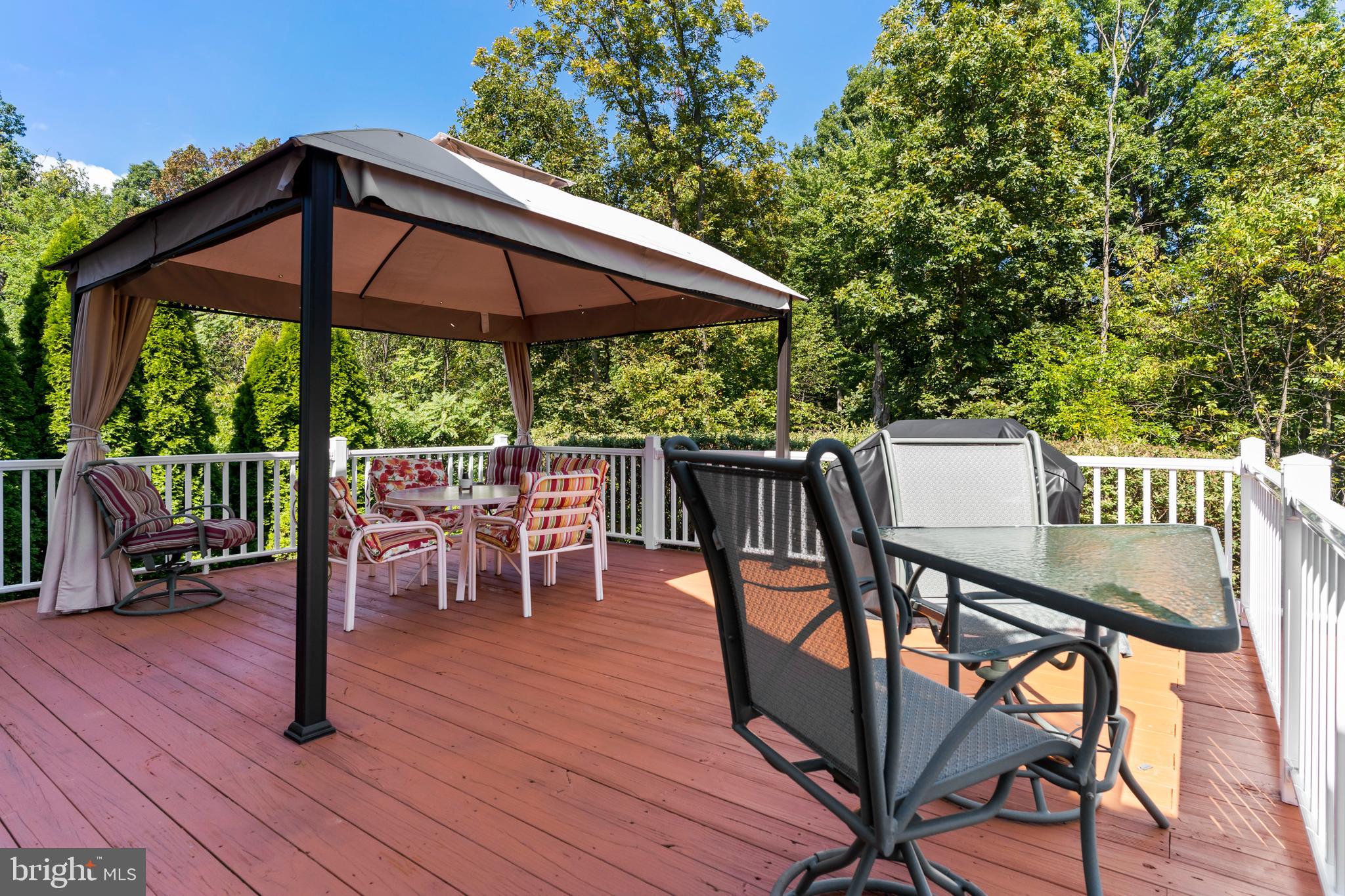 152 St Michaels Way Hanover, PA 17331 - Photo 31 of 37 a view of a roof deck with table and chairs under an umbrella with wooden floor and fence
