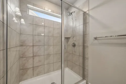 a bathroom with a shower and a mirror