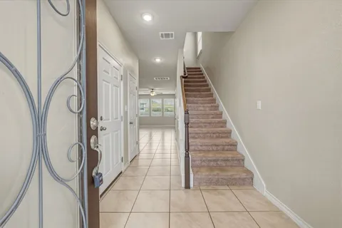 a view of a hallway with wooden floor and staircase