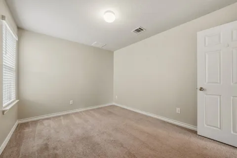 an empty room with a empty space and windows