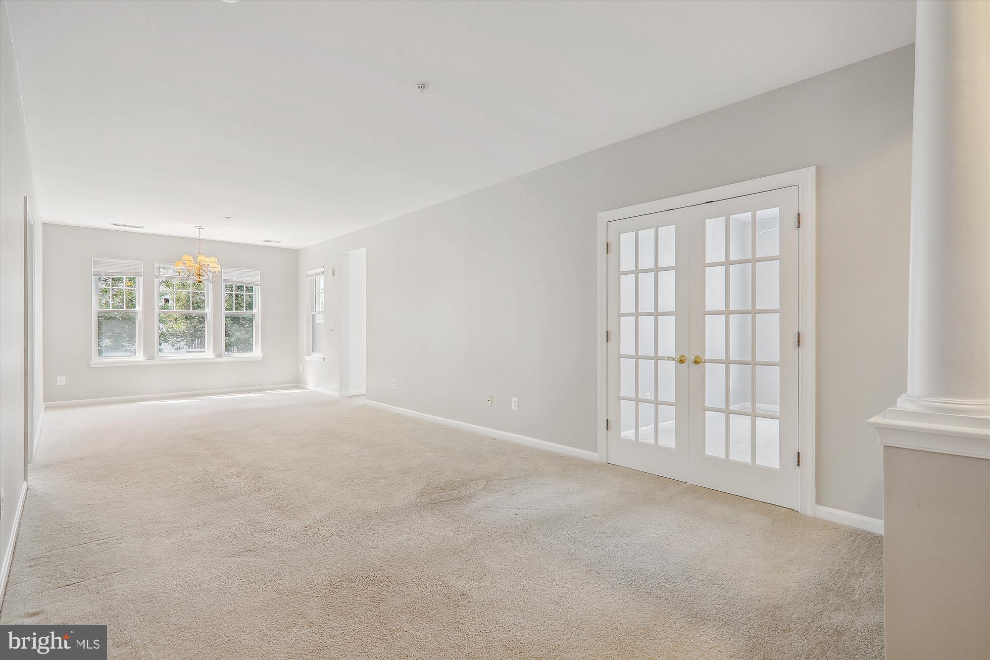 13851 Belle Chasse Boulevard, Unit 213 Laurel, MD 20707 - Photo 12 of 54 an empty room with windows