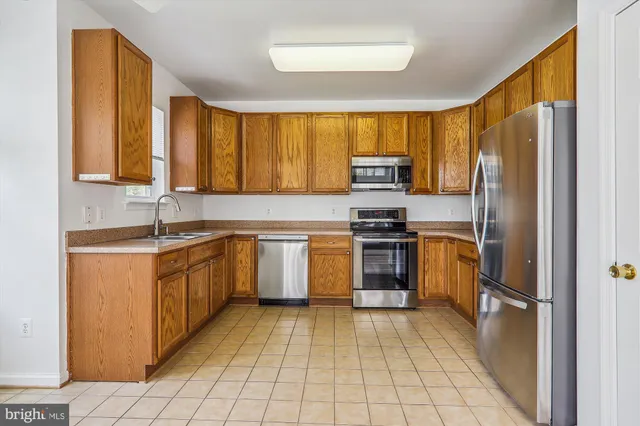 a kitchen with a sink stove and refrigerator