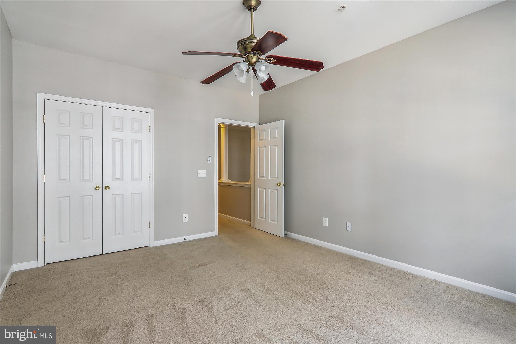 13851 Belle Chasse Boulevard, Unit 213 Laurel, MD 20707 - Photo 23 of 54 a view of an empty room with a chandelier fan