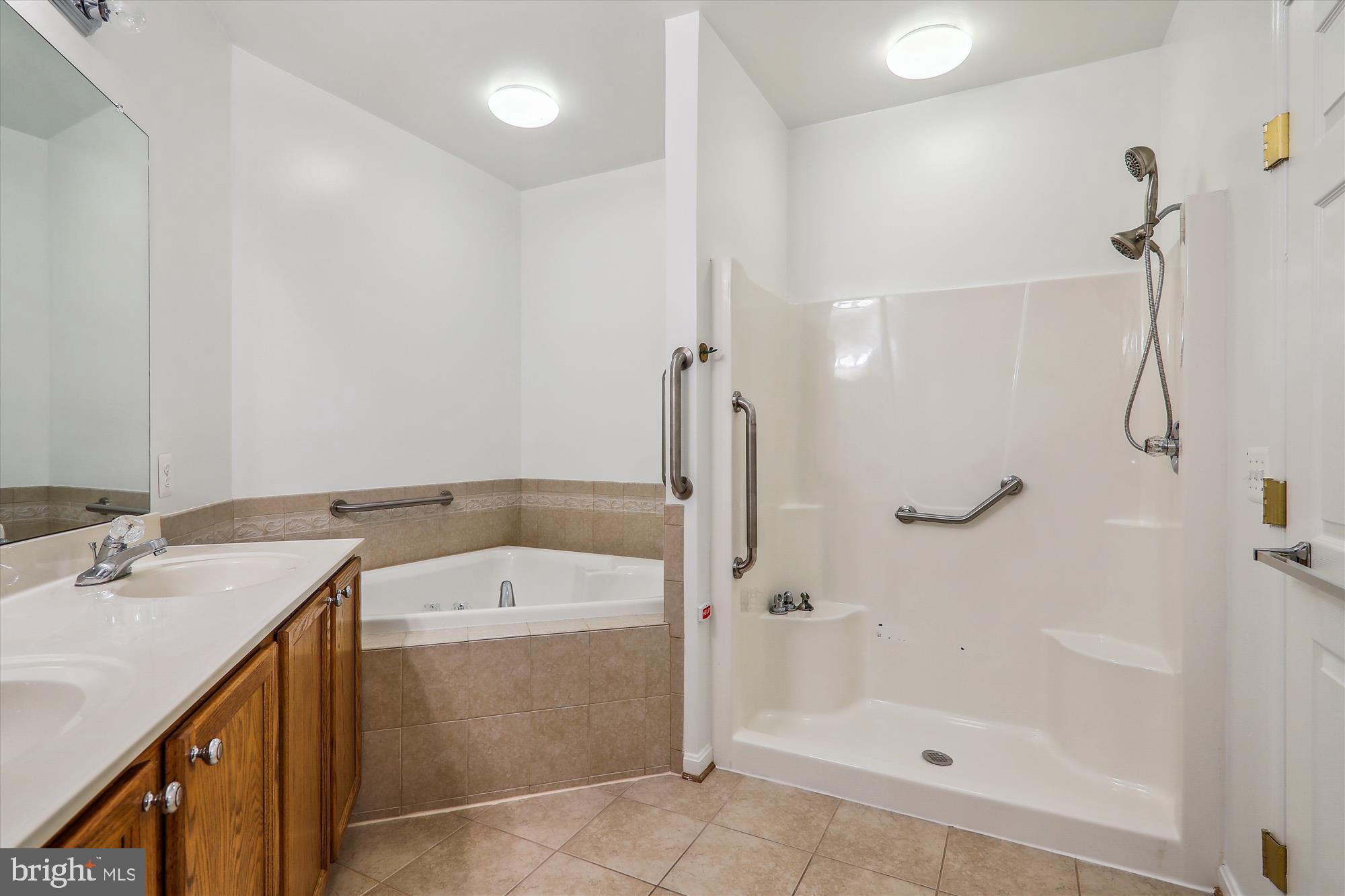 13851 Belle Chasse Boulevard, Unit 213 Laurel, MD 20707 - Photo 27 of 54 a bathroom with a tub sink and mirror