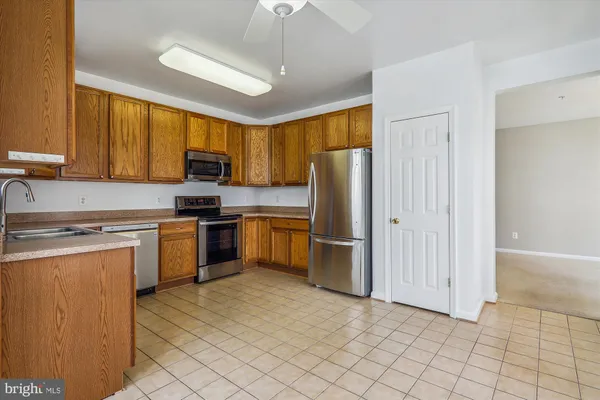 a kitchen with a refrigerator sink and microwave