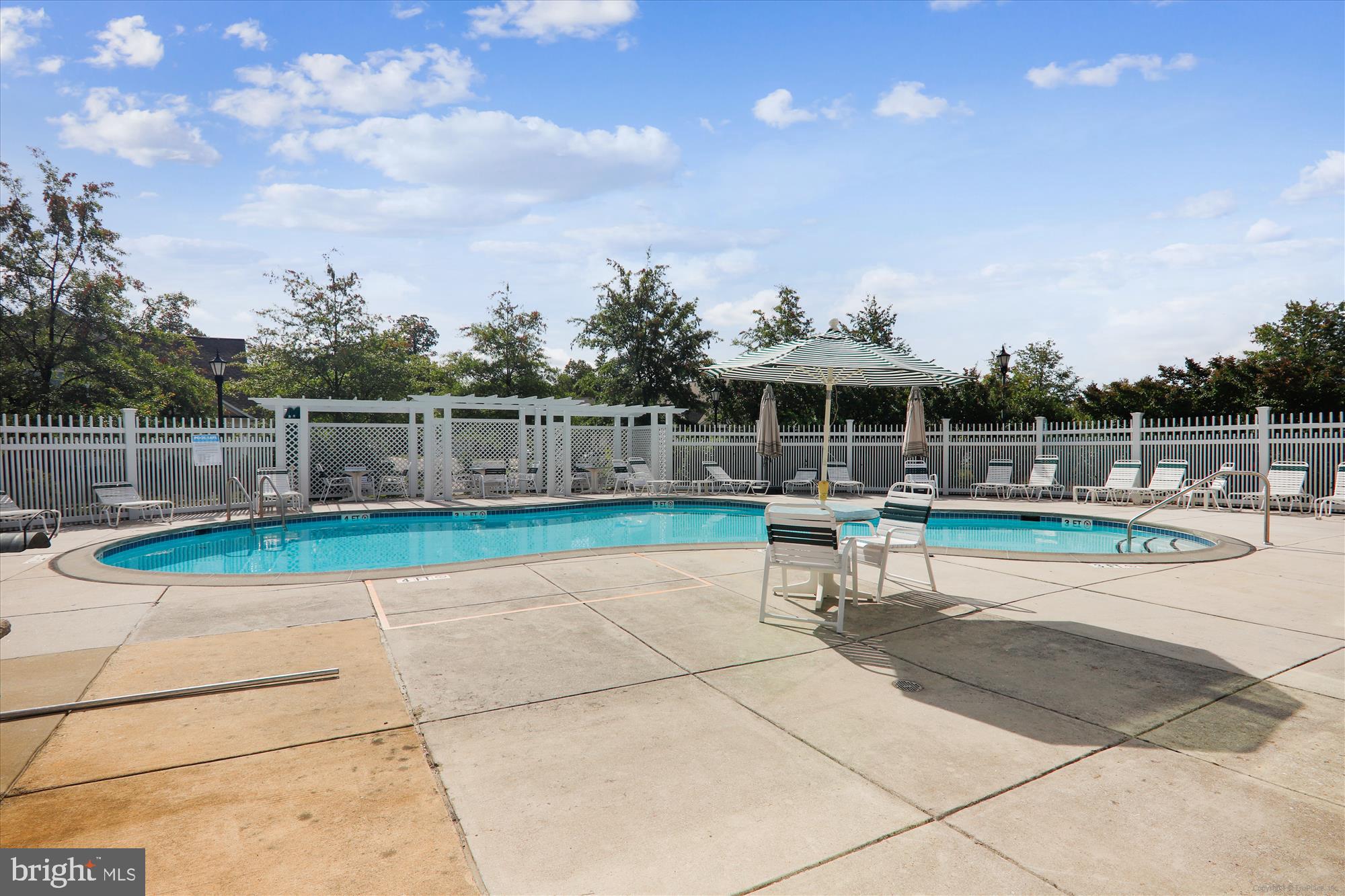 13851 Belle Chasse Boulevard, Unit 213 Laurel, MD 20707 - Photo 42 of 54 a view of a swimming pool with a patio