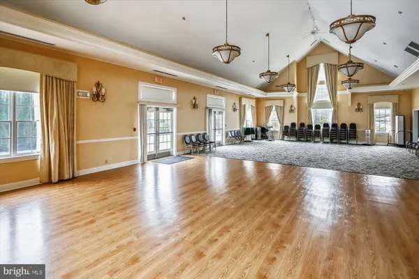 a living room with furniture kitchen view and a flat screen tv
