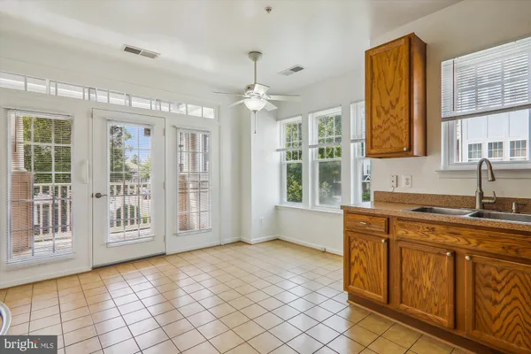 a view of a kitchen with a sink and windows