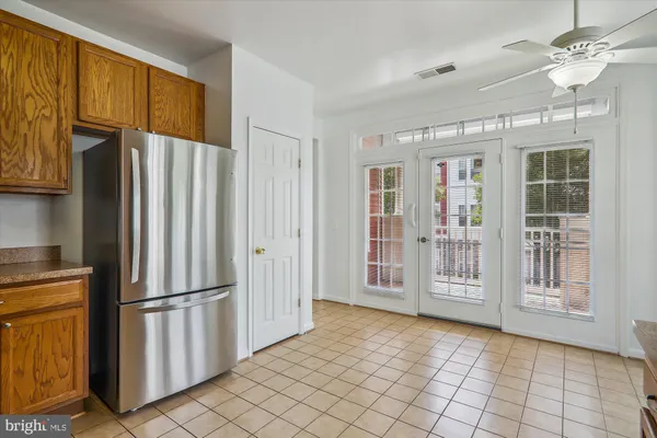 a view of kitchen with windows and refrigerator