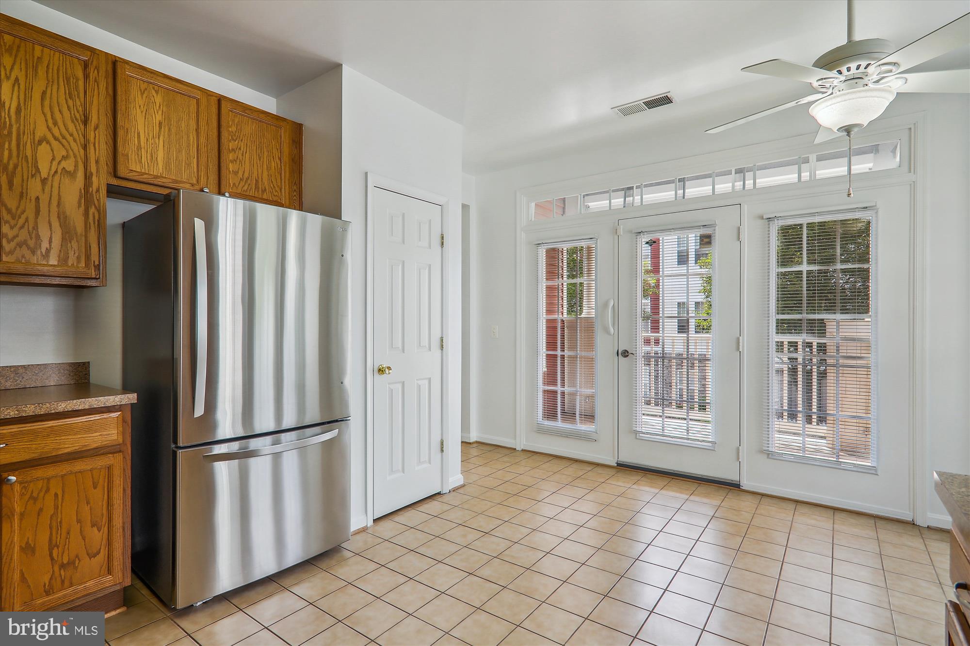 13851 Belle Chasse Boulevard, Unit 213 Laurel, MD 20707 - Photo 6 of 54 a view of kitchen with windows and refrigerator