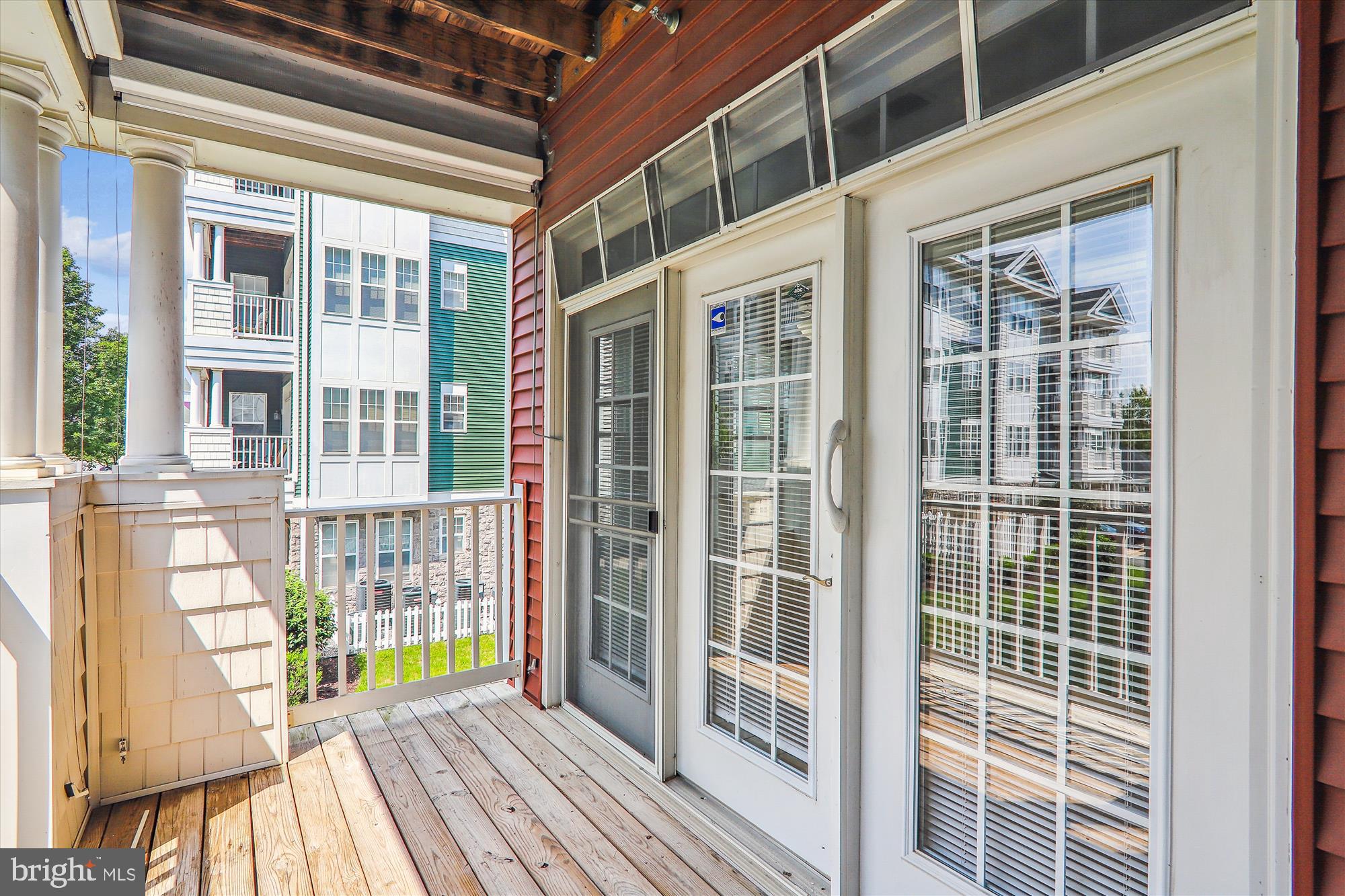 13851 Belle Chasse Boulevard, Unit 213 Laurel, MD 20707 - Photo 8 of 54 a view of a brick building from a balcony