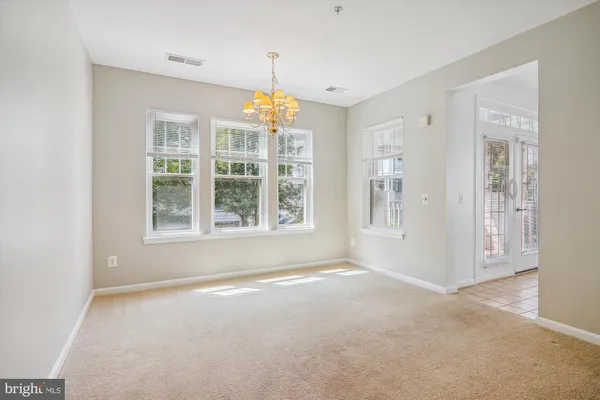 an empty room with a empty space and windows