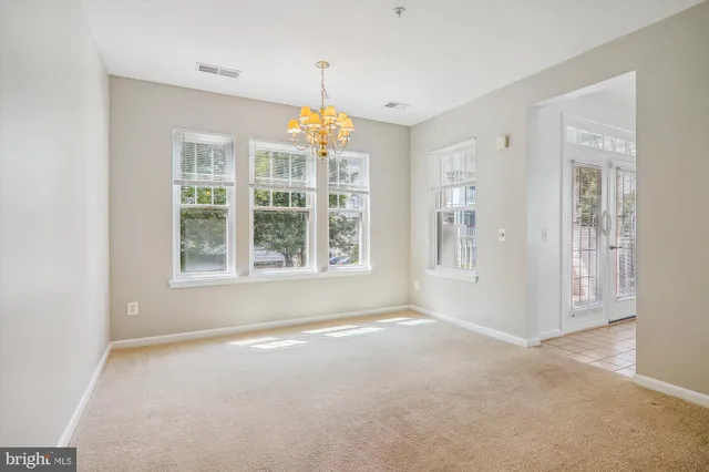 an empty room with a empty space and windows