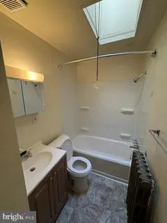 a bathroom with a sink a toilet and a bathtub