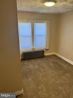 a view of a room with wooden floor and window