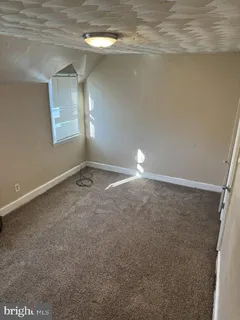 a view of empty room with stairs