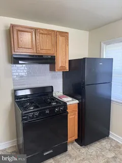 a kitchen with stainless steel appliances granite countertop a stove a refrigerator and a cabinets