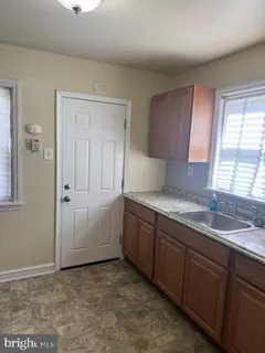 a kitchen with granite countertop a sink and cabinets