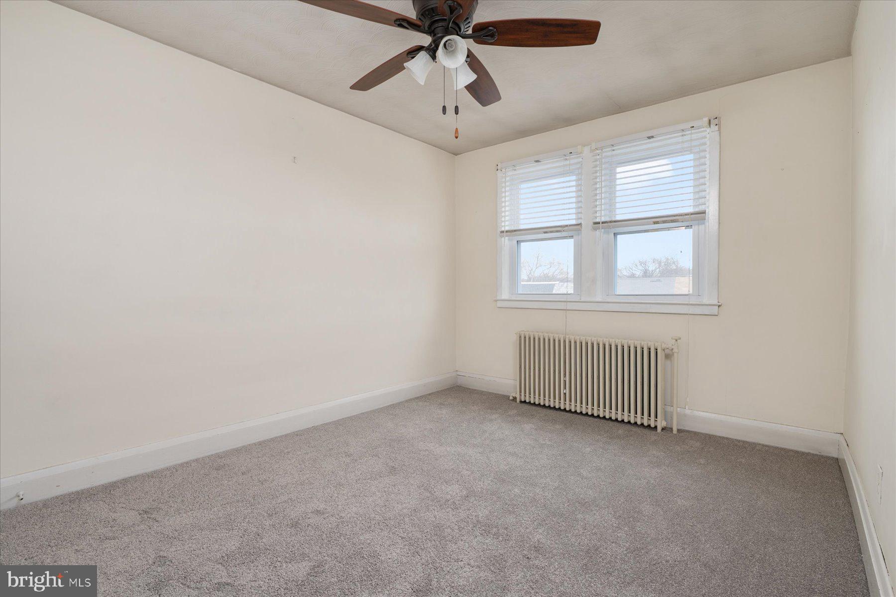 179 West Meadow Road Baltimore, MD 21225 - Photo 23 of 34 an empty room with chandelier fan and windows