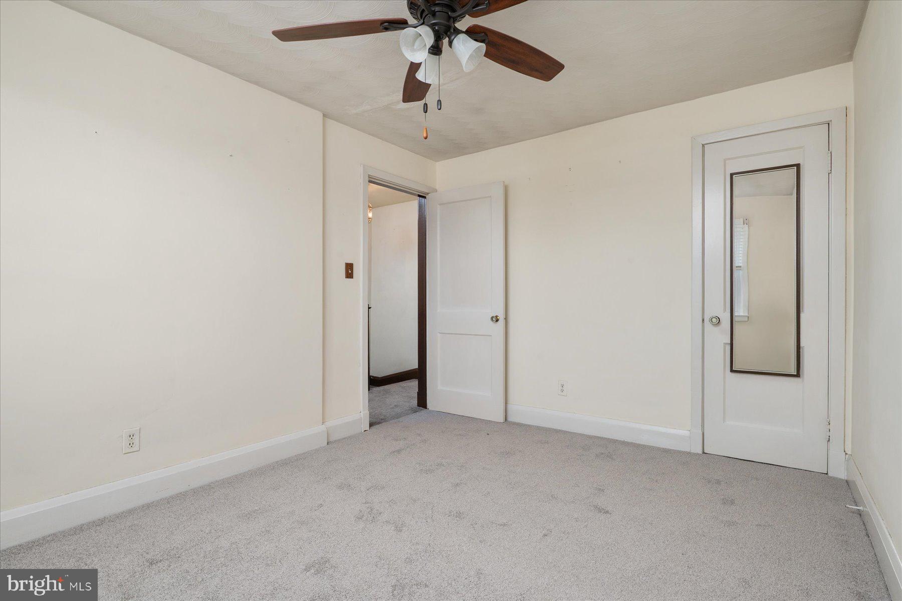 179 West Meadow Road Baltimore, MD 21225 - Photo 24 of 34 an empty room with a ceiling fan and carpet