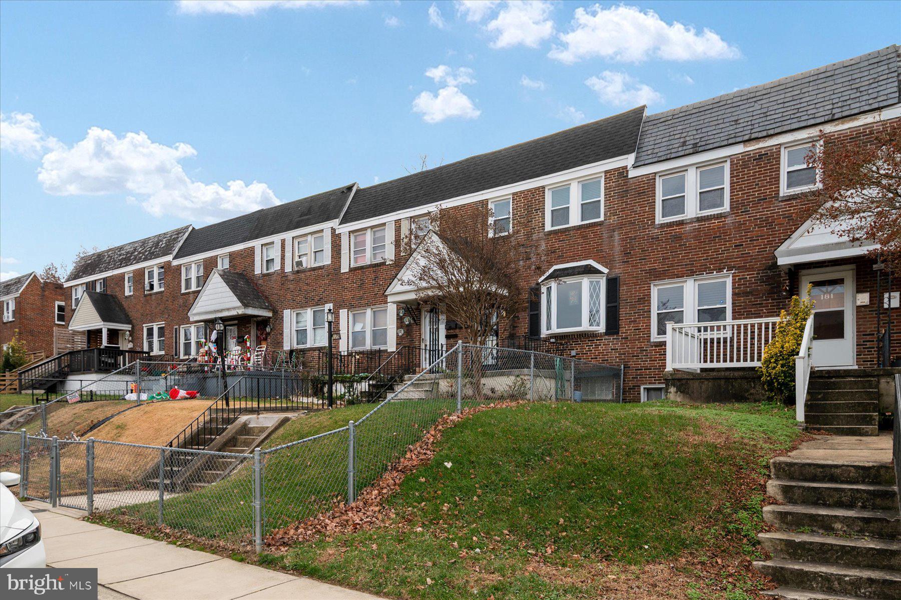 179 West Meadow Road Baltimore, MD 21225 - Photo 4 of 34 a front view of a house with a yard