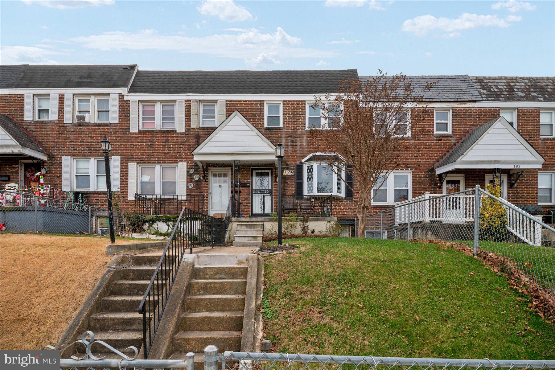 179 West Meadow Road Baltimore, MD 21225 - Photo 5 of 34 a front view of a house with a yard