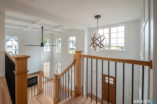 a view of a hallway with wooden floor and entryway