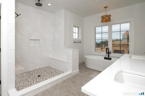 a bathroom with a bathtub shower and toilet