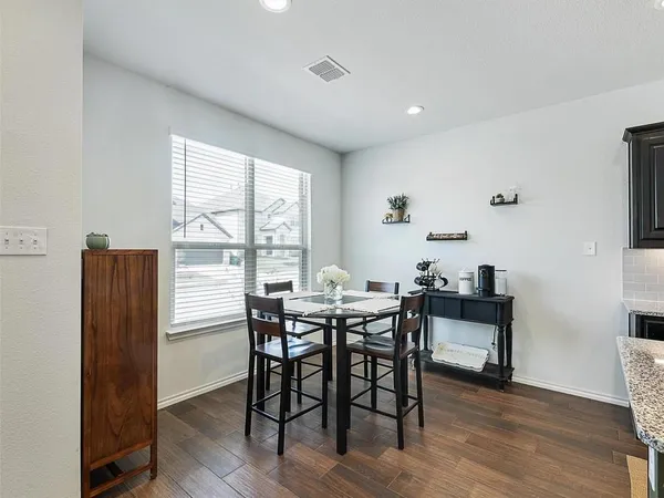 a view of a dining room with furniture and wooden floor