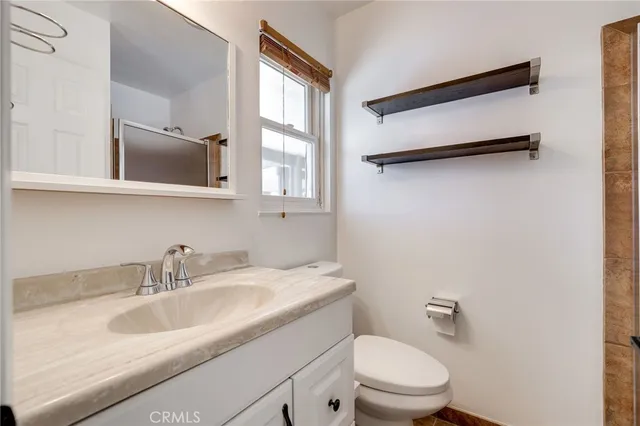 a bathroom with a sink toilet and mirror