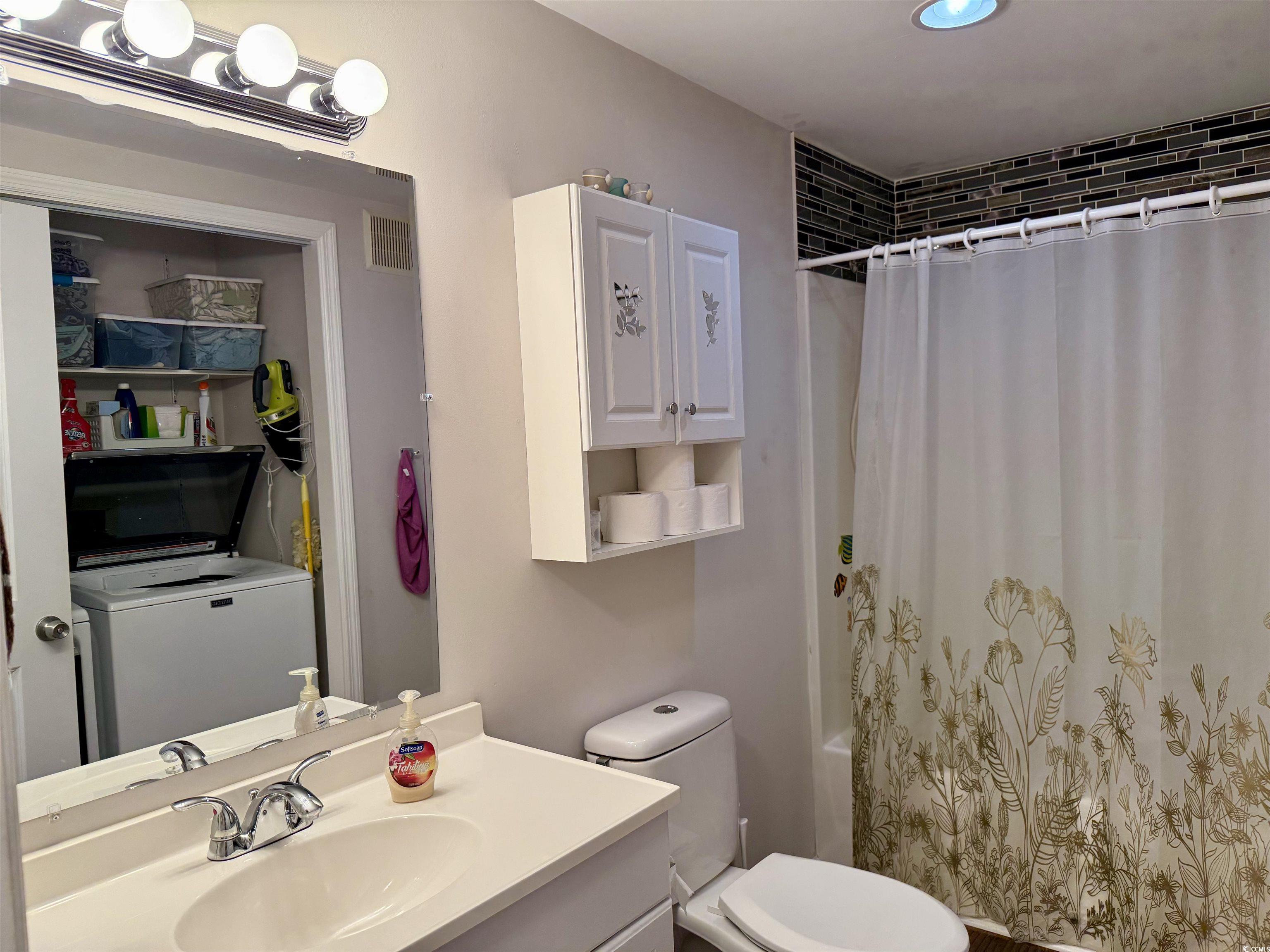 1760 Egret Surfside Beach, SC 29575 - Photo 14 of 29 Bathroom featuring vanity, shower / bathtub combination with curtain, and washer / clothes dryer