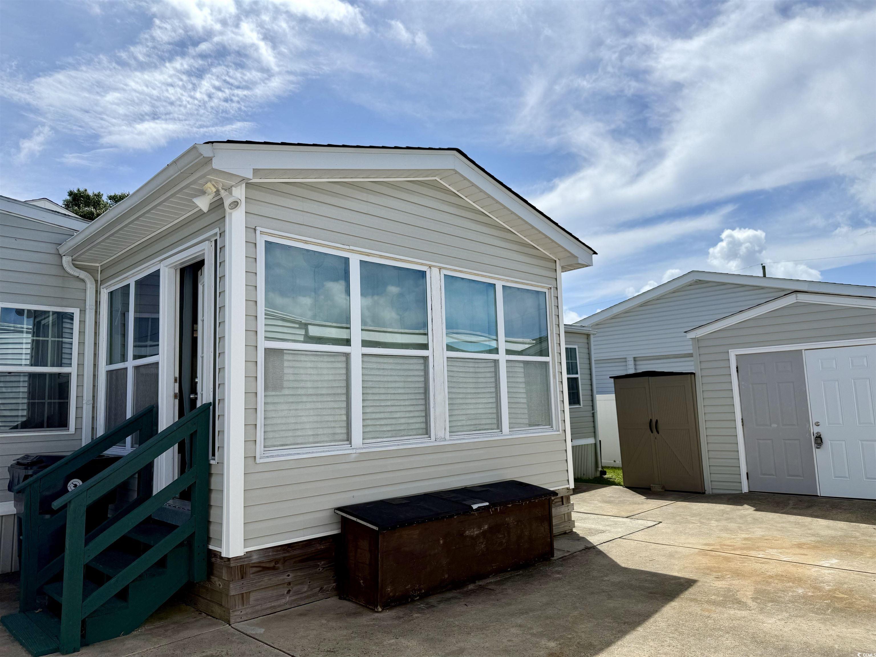 1760 Egret Surfside Beach, SC 29575 - Photo 19 of 29 View of side of property featuring a storage shed, a patio area, and entry steps