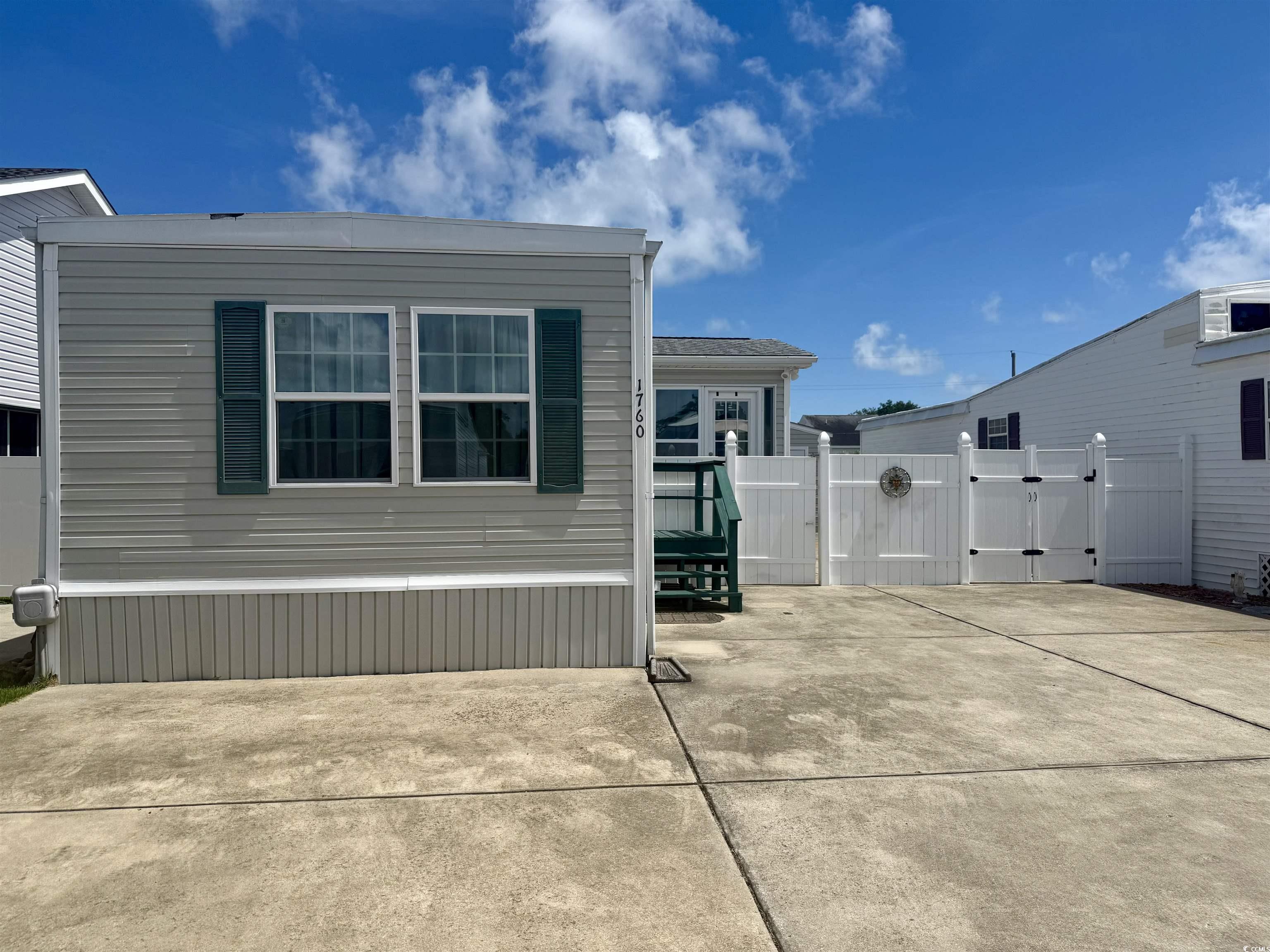 1760 Egret Surfside Beach, SC 29575 - Photo 21 of 29 View of side of home with a gate and a patio area