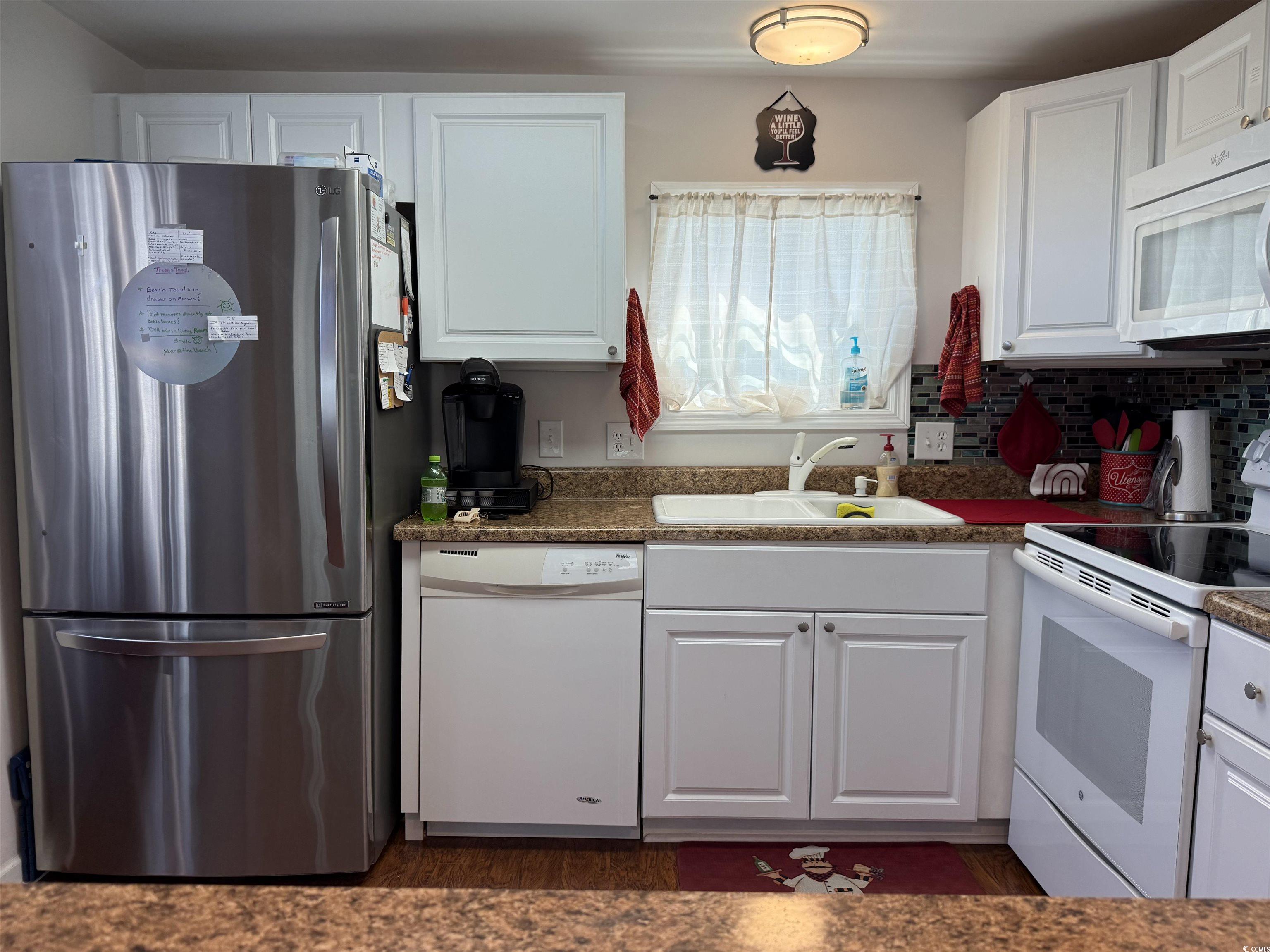 1760 Egret Surfside Beach, SC 29575 - Photo 7 of 29 Kitchen with white appliances, white cabinets, and wood finished floors