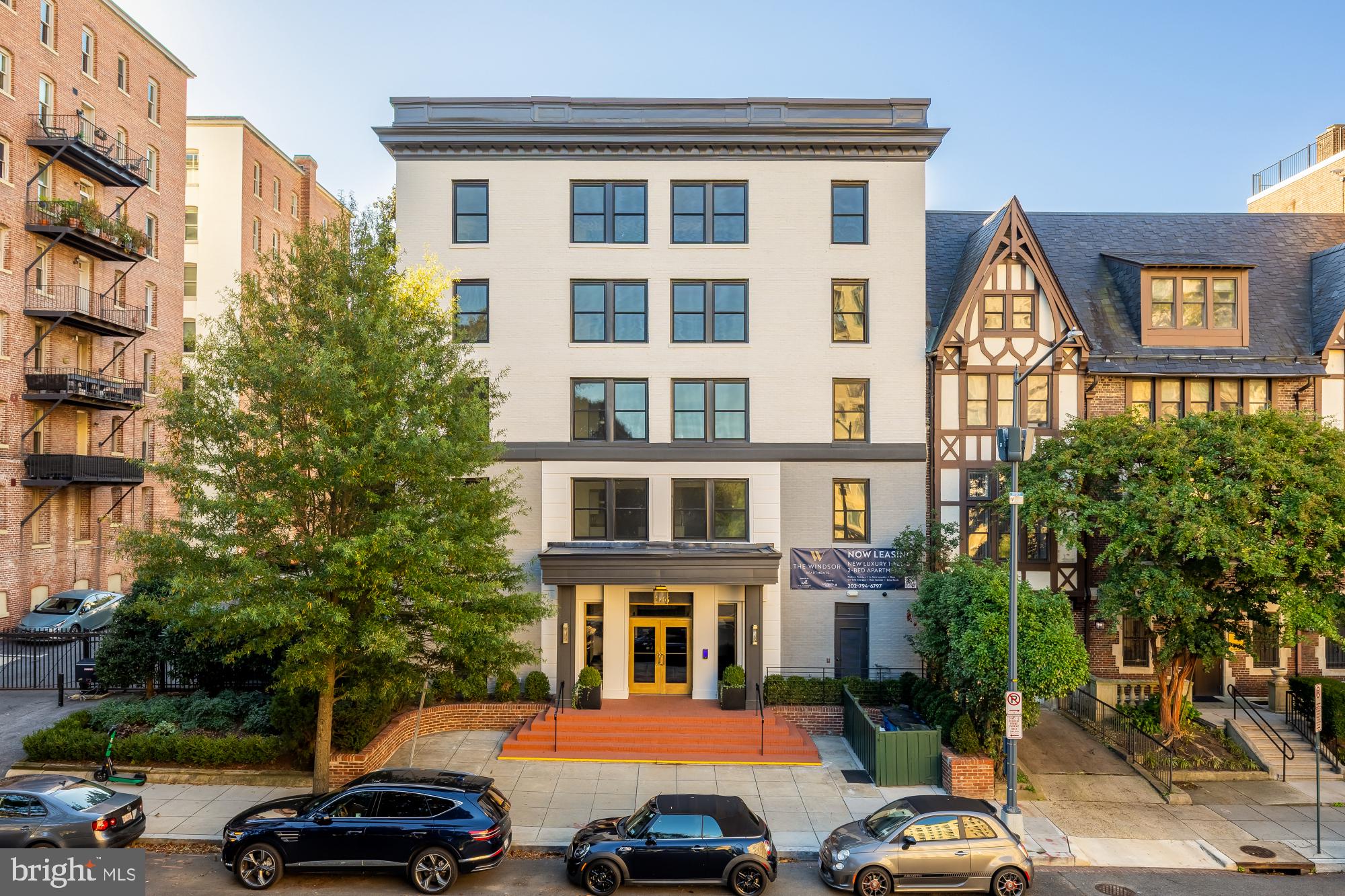 a front view of a residential apartment building with a yard