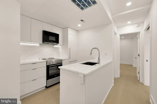 a kitchen with a microwave and cabinets