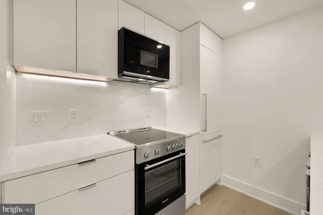 a stove top oven sitting inside of a kitchen