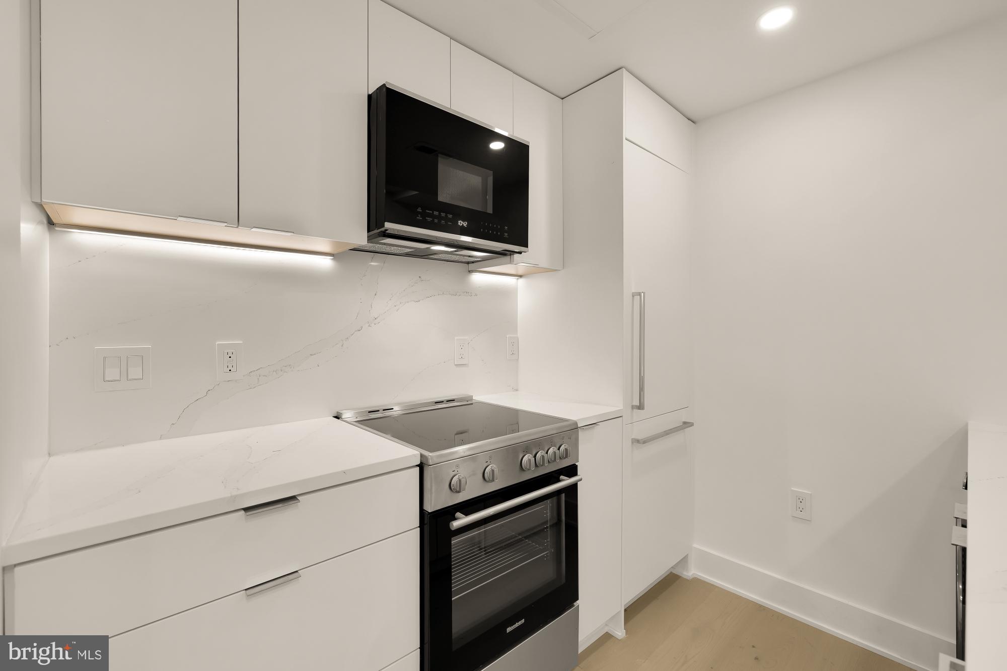 2116 Kalorama Road Northwest, Unit 104 Washington, DC 20008 - Photo 12 of 33 a kitchen with a microwave and cabinets