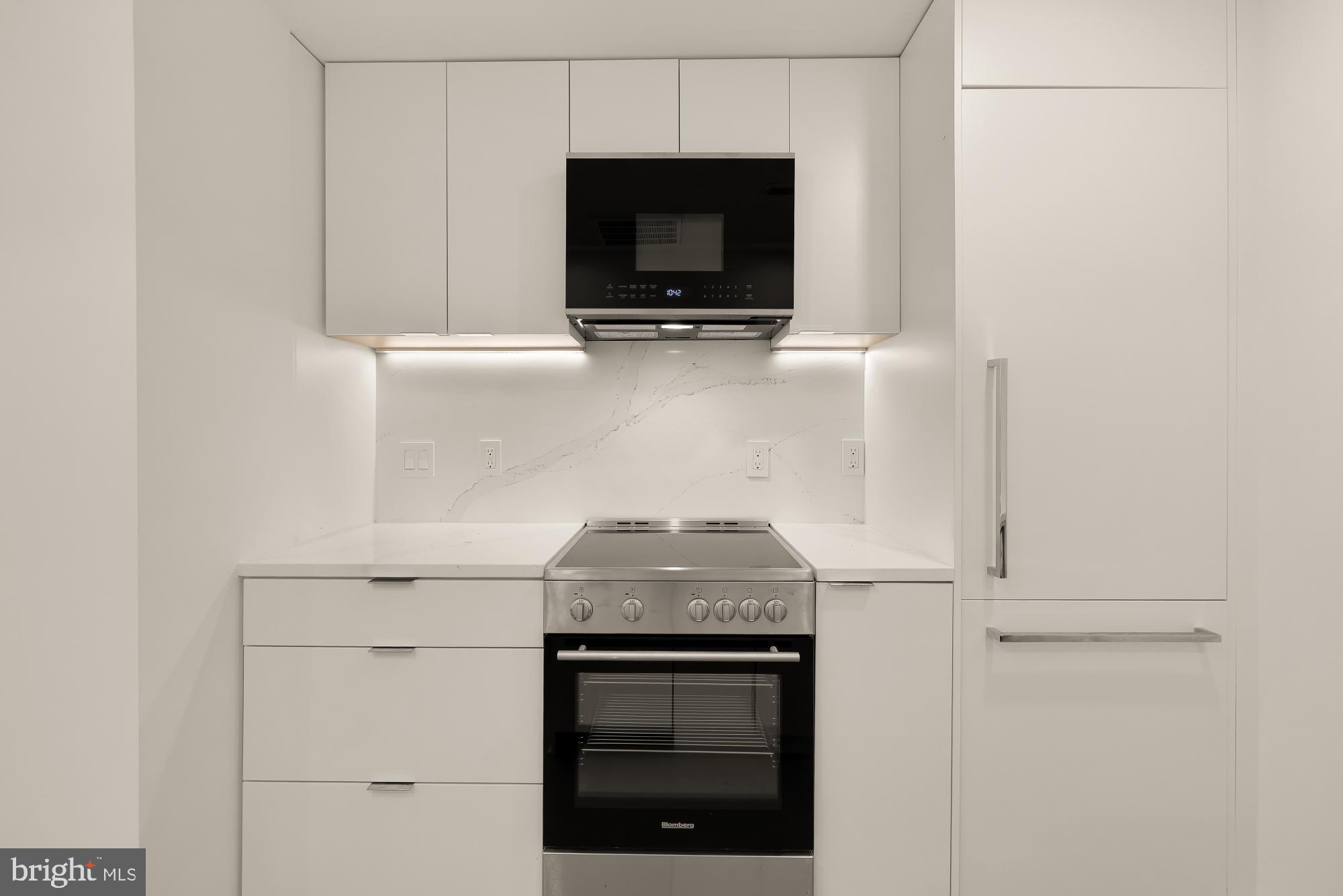 2116 Kalorama Road Northwest, Unit 104 Washington, DC 20008 - Photo 13 of 33 a stove top oven sitting inside of a kitchen