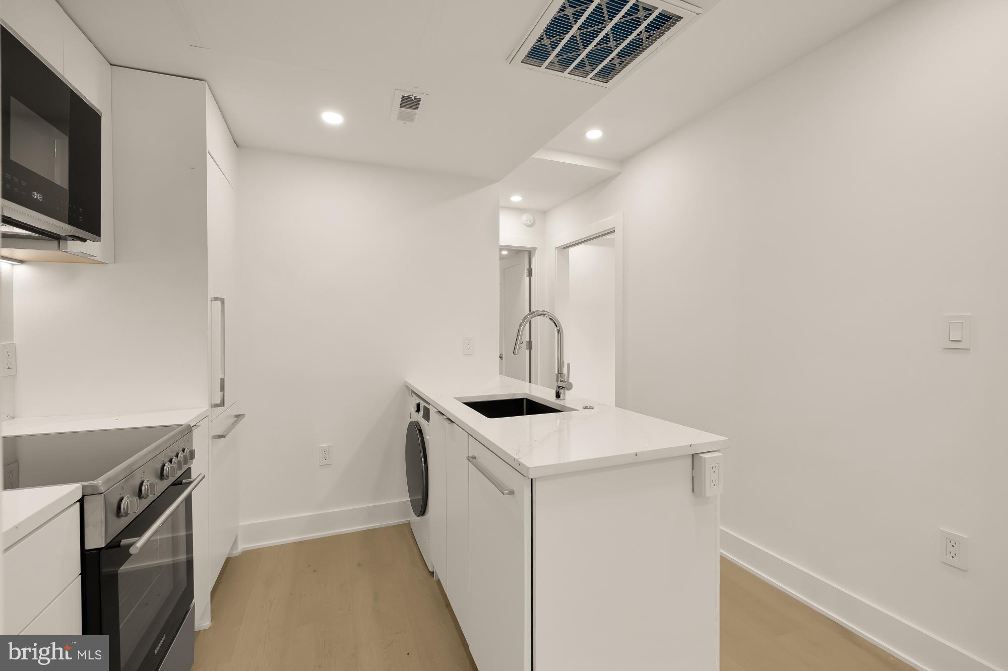 2116 Kalorama Road Northwest, Unit 104 Washington, DC 20008 - Photo 14 of 33 a view of storage and utility room with a sink